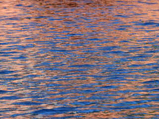 abstract water reflection of pink and blue, wave texture