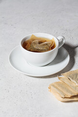 Fresh herbal tea in white cup. Herbal tea bags, copy space.