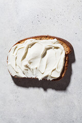 Cream cheese toast on gray background, top view. Minimalism concept.