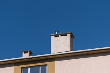 Fototapeta na wymiar concrete and tin pipe chimney on the roof, 