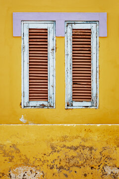 Yellow Wall With Close Window Shutters