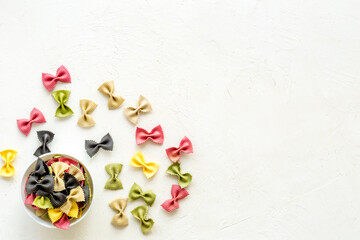 Top view of coloured farfalle pasta in bowl