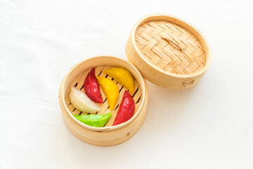 Asian steamed dumplings in wooden steamer. Traditional Chinese dim sum set