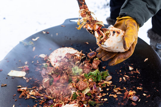 Preparing food over campfire