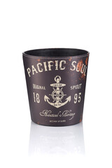 Subject shot of brown leather wastebasket with retro print of nautical heritage ocean sign. The stylish wastepaper basket is isolated on reflecting white surface.