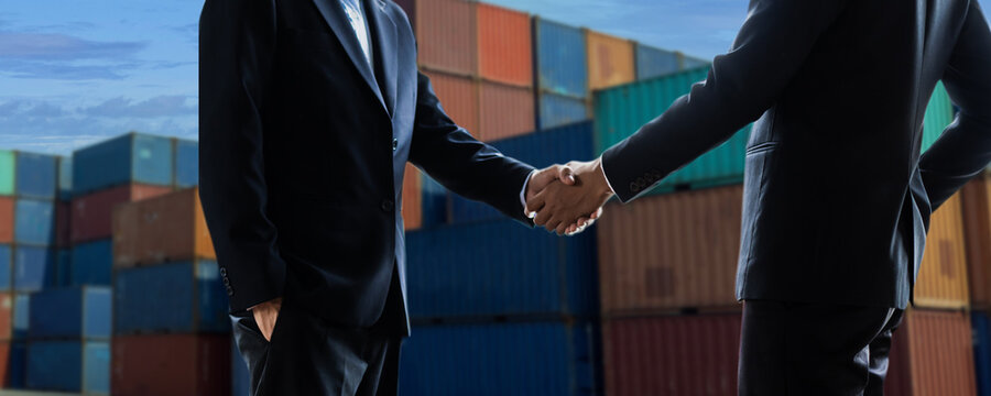 Export And Import Cargo Business Concept. Close Up Hand Of Businessmen Shaking Hand At Industrial Container Terminal. Maritime Transport And Logistics, Successful Agreement And Success In Contract