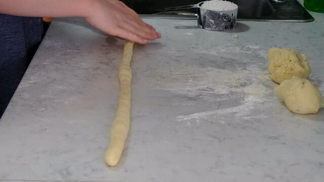Cutting gnocchi into small pieces 