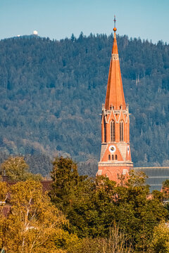 Beautiful autumn or indian summer view with a red church and the famous Arber summit in the background near Zwiesel, Bavarian forest, Bavaria, Germany