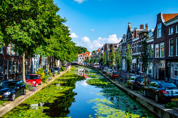 Delft, Netherlands - July 11, 2019: View of canals and brick houses of the town of Delft in the Netherlands - 417357035