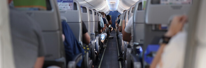 In cabin of the plane are passengers preparing for flight. Travel and travel by air transport concept