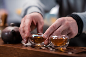 The mystery of a real chinese tea ceremony. The master's hands prepare delicious black tea for the guests of his house