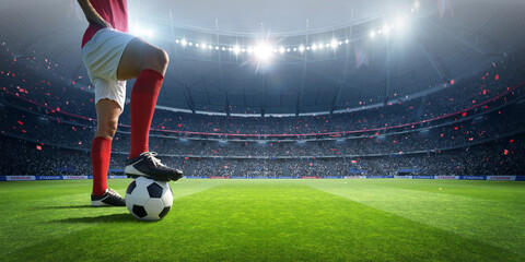 Fototapeta Football player in the stadium. An imaginary stadium is modelled and rendered. obraz
