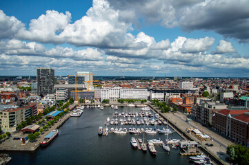 Obraz premium Antwerp, Belgium - July 12, 2019: Aerial view of Antwerp, Belgium, on a sunny summer day with beatiful clouds above the harbor.