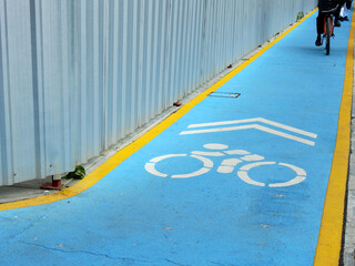 Blue bicycle path on footpath