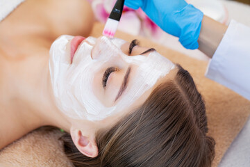 Naklejka premium Pretty woman relaxes during spa treatments at beauty salon