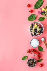 Coloured vegan pasta with tomatoes and fresh basil, view fron above