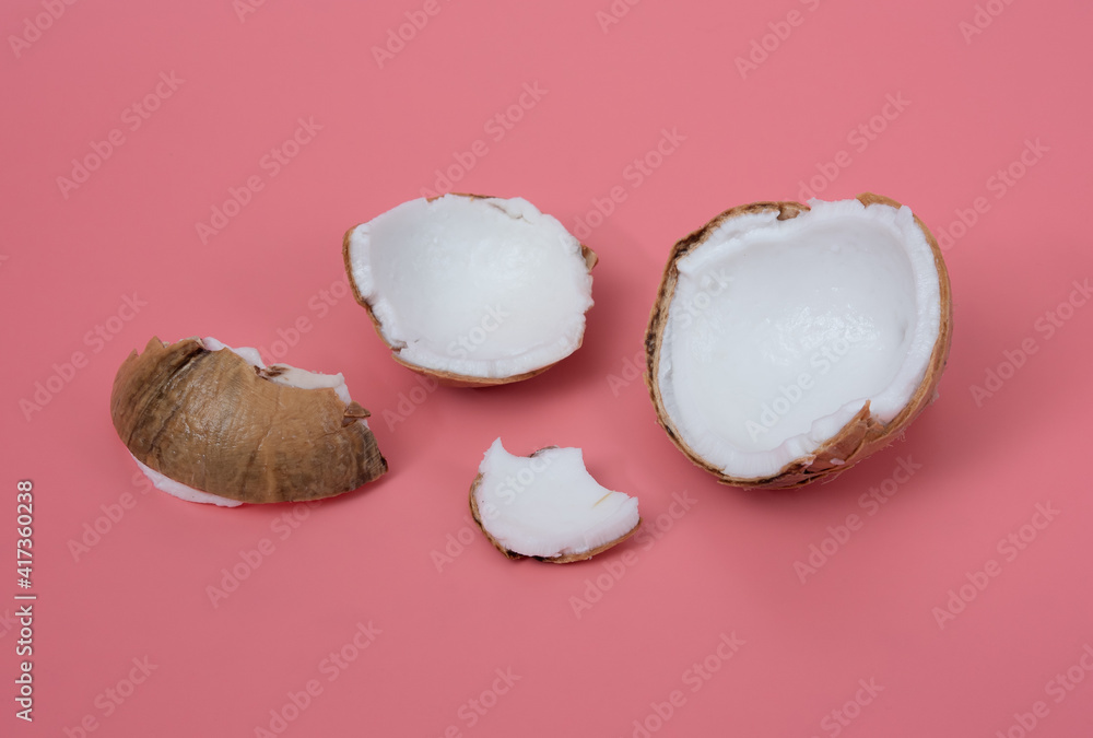 Sticker parts of fruits coconut on a pink background,cracked coconut