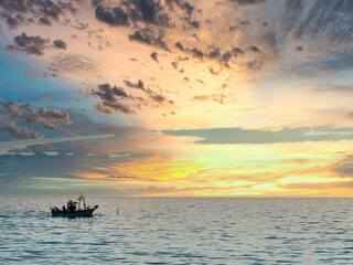 Fishing boat at dawn heading to collect the nets