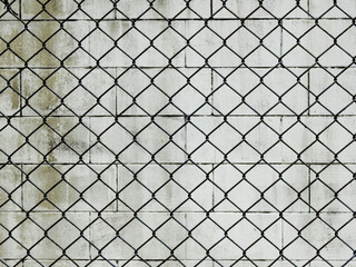 wire mesh of fence with dirty white wall background