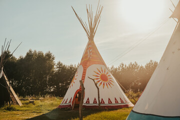 Tipi house in the forest against the background of trees, camping, village in the forest, camping....
