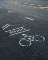 Fototapeta premium Bicycle sign and arrow on asphalt road texture