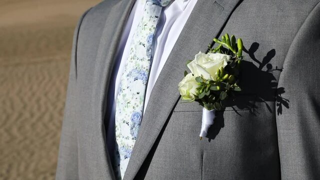 Groom Wearing Handsome Suit and Tie and Flower Corsage for Wedding, closeup