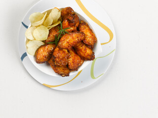 plate of marinated chicken wings, on white background