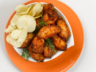 plate of marinated chicken wings, on white background