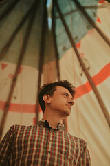 A man lives in a field in a teepee house. The guy travels a lot and enjoys life. An interesting...