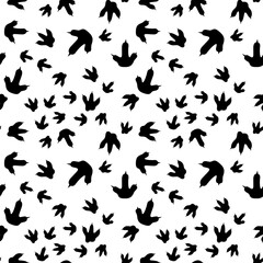 Obraz premium Dinosaur footprint tracks. Minimal seamless pattern. Background with paw, claw predator. Dinosaur footprint illustration perfect for textile, wrap and wallpaper and design.
