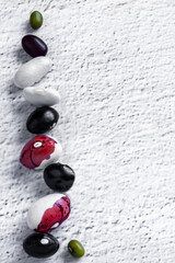 Vegan protein balance diet with mix legume copy space light background. Balancing act vegetarian food concept.