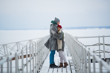 The husband arranged an exit date for his wife in the winter on the river pier in the snow, they...