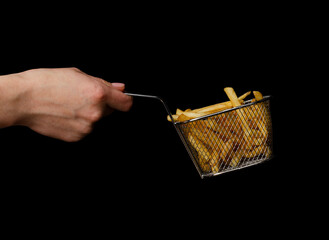 French fries in a basket on hand isolated