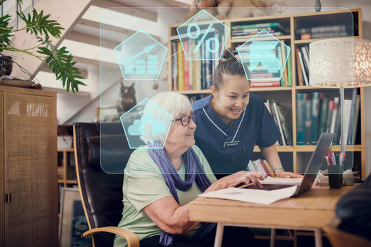 Home carer helping senior woman to use laptop