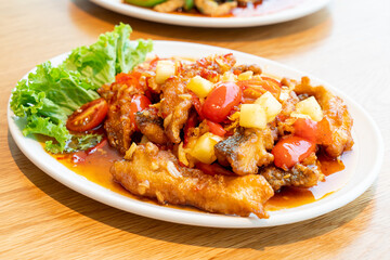 fried grouper fish topped with sweet ,sour and hot sauce