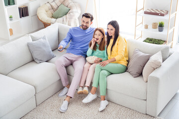 Obraz premium Top above high angle view full body photo of family happy positive smile sit couch indoors watch film eat popcorn remote controller