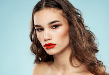 Fototapeta premium Elegant brunette woman with red lips bared shoulders and eye shadow cropped view