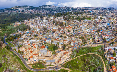 Safed old Jewish quarter houses, with light snow covering rooftops, Aerial view.