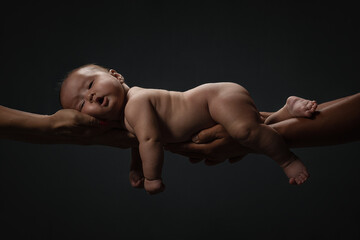 Baby Newborn Sleeping On Parents Hands over dark background, Kid And Family Concept