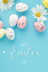 Happy easter poster with eggs and daisies on a blue background