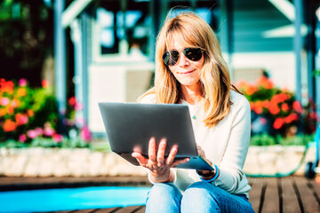 Confident woman using laptop while while working from home in the garden