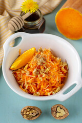 Fresh healthy vegetarian salad with butternut squash, apples and walnuts