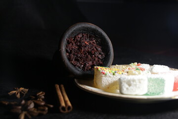 bowl with hookah tobacco. berries on a black background. shiisha smoking