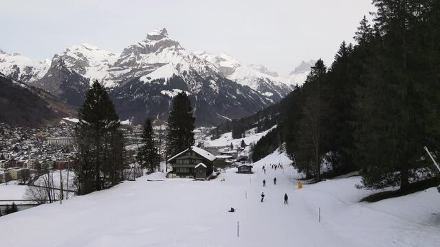 Areal view of people skiing at Engelberg on the Swiss alps
