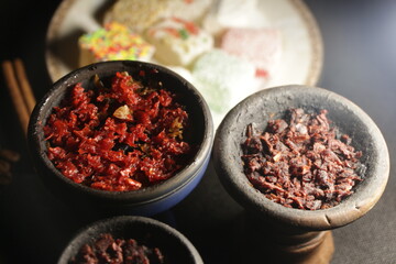 bowl with hookah tobacco. berries on a black background. shiisha smoking