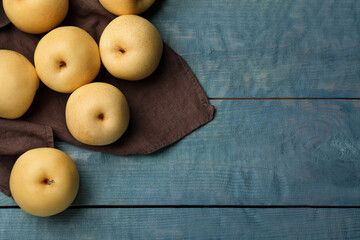 Ripe apple pears on blue wooden table, flat lay. Space for text