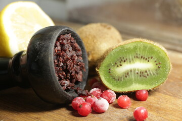 bowl with hookah tobacco. berries on a black background. shiisha smoking