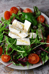 Delicious salad with feta cheese and cherry tomatoes. Healthy diet. A plate of salad. Spring food.