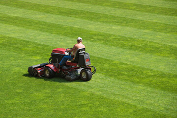Mowing grass at the football stadium
