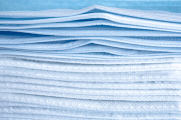 stack of surgical face masks,background white and blue